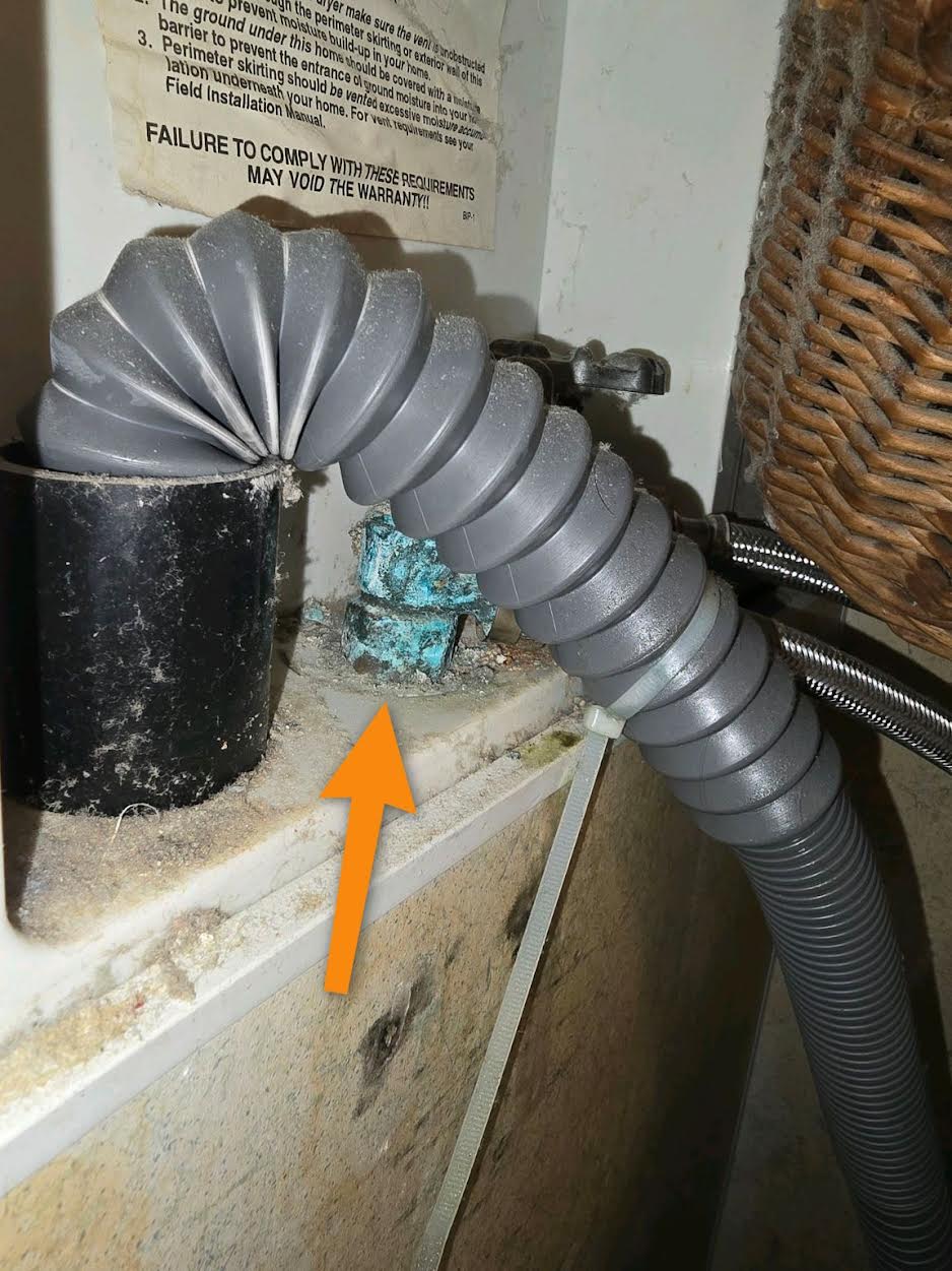 Mineral buildup and staining from a slow leak at a bathroom sink P-trap found in Prosper, TX