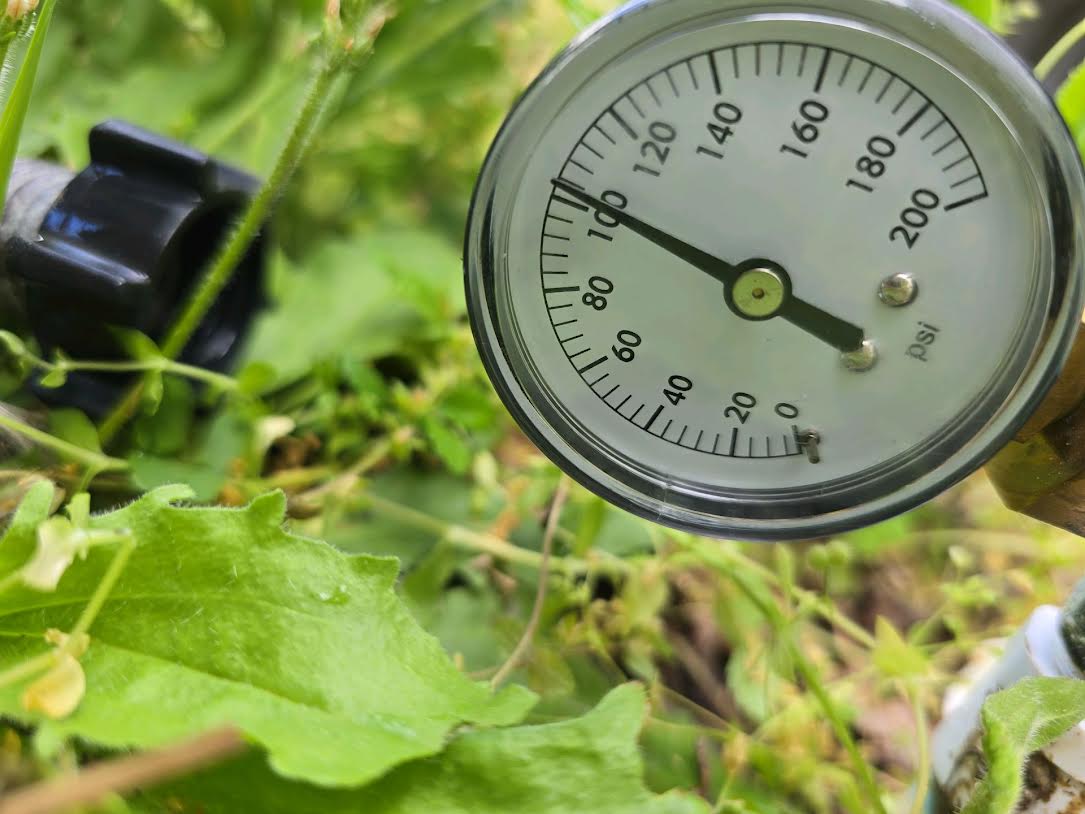Pressure gauge on a hose bibb showing water pressure above the acceptable range in Anna, TX