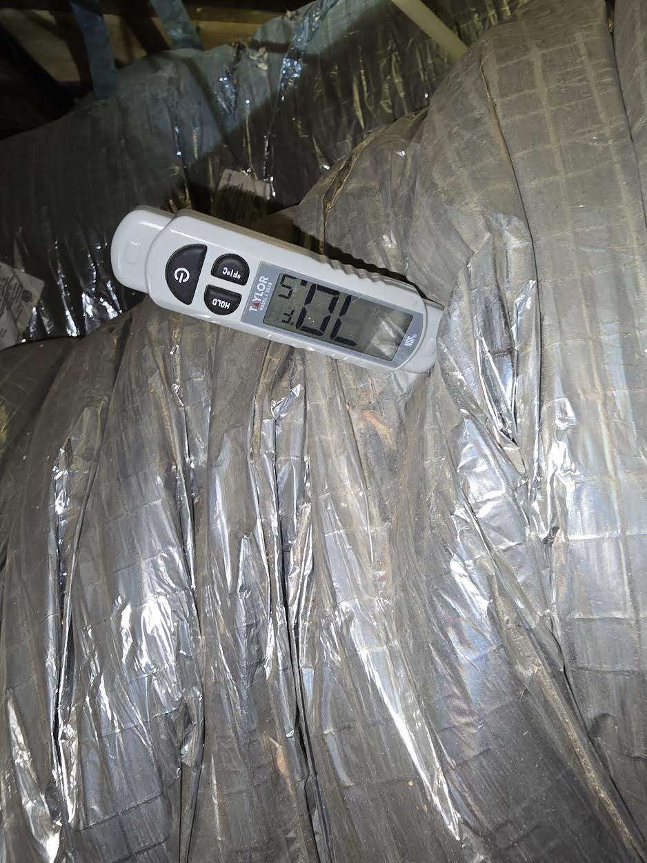 Digital thermometer taking a return air temperature reading at the HVAC ductwork in an attic in McKinney, TX