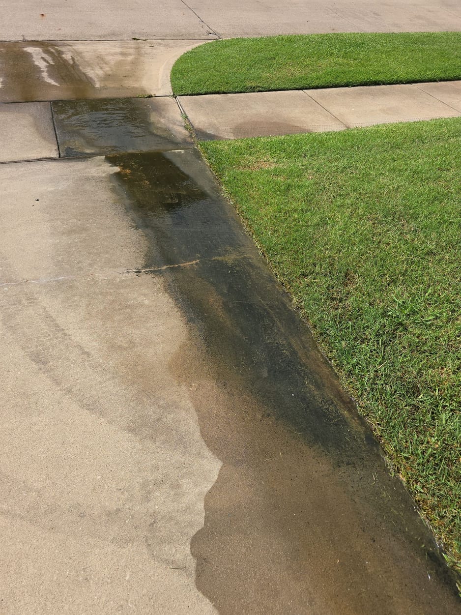 Irrigation runoff flowing off the lawn and across the sidewalk and driveway, documented on a North Texas inspection